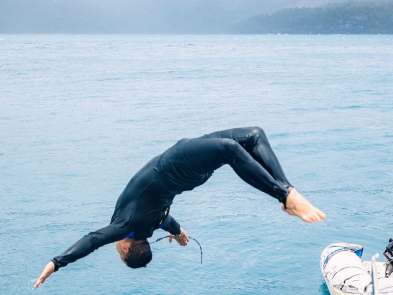 a man riding a wave on top of a body of water